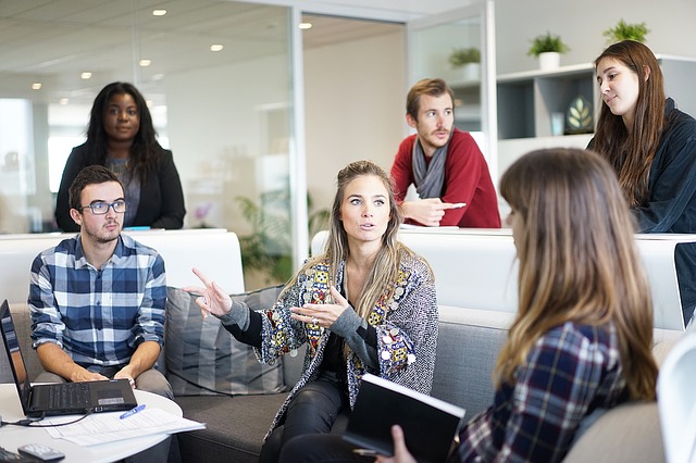 A group of colleagues talking in an office